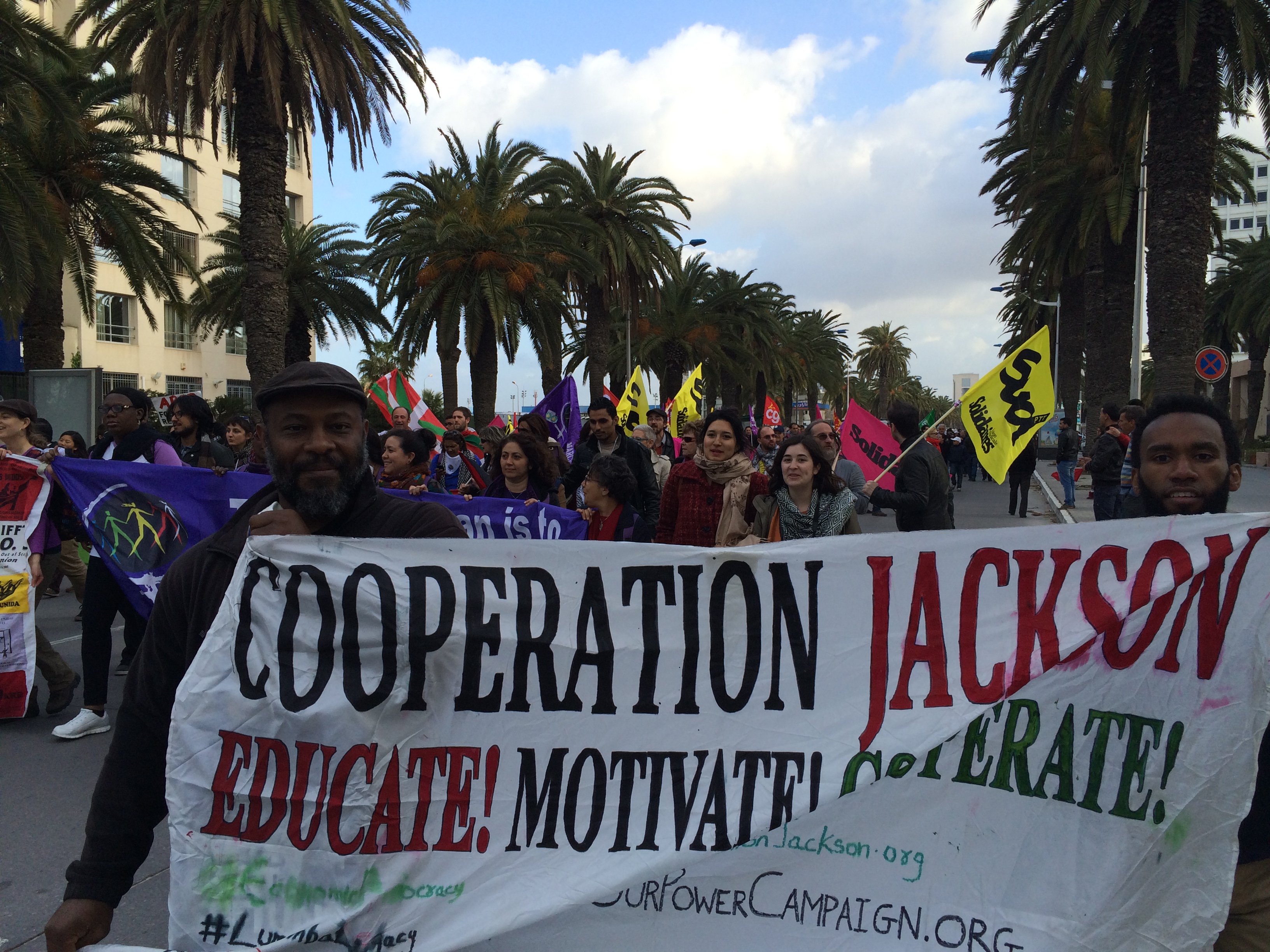 Kali and Adofo representing Cooperation Jackson at the 2015 World Social Forum march for Palestine in Tunis